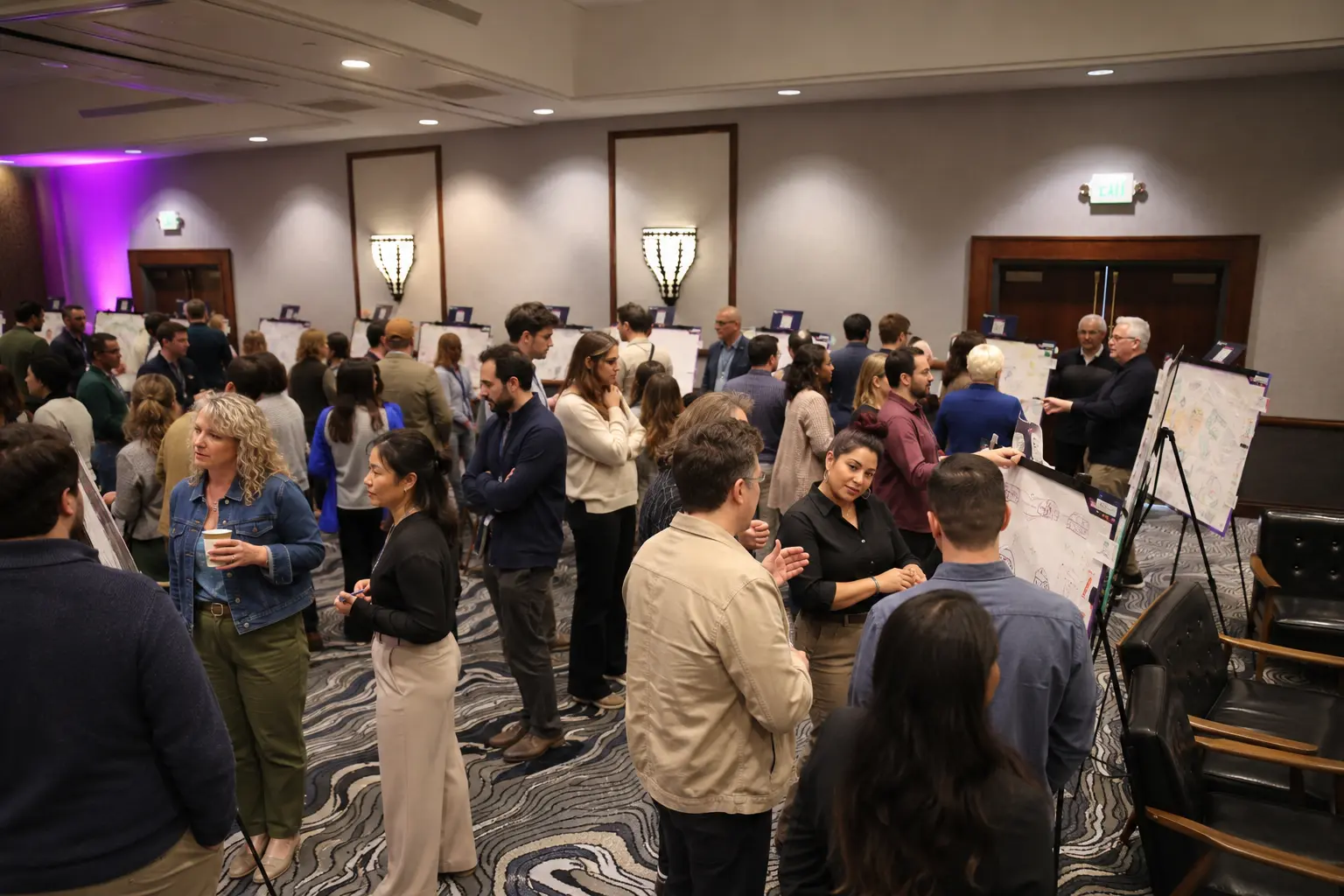 A large group reviewing proposals during a gallery walk
